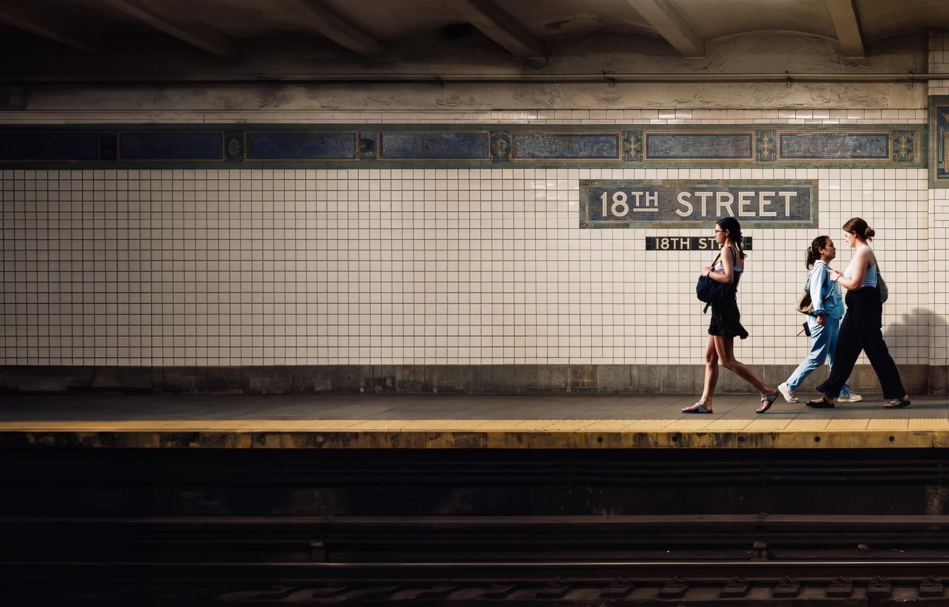 People walking past the 18th Street subway station