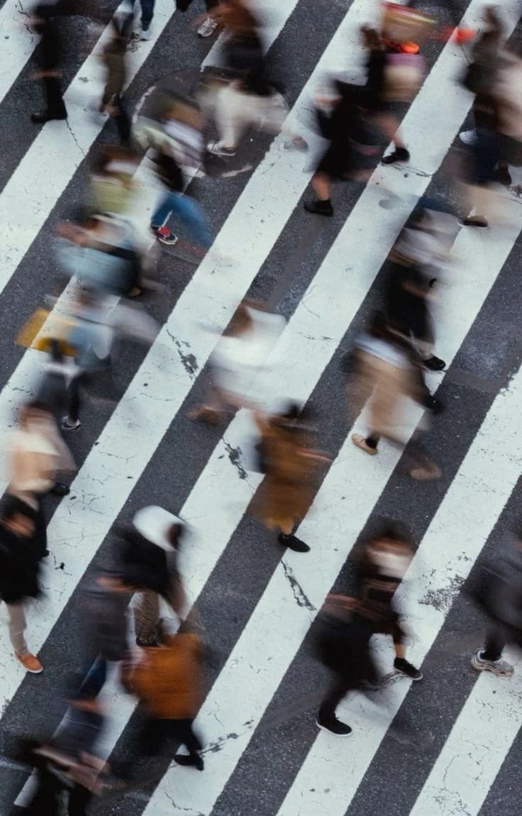 Pedestrians crossing a street, seen in motion
