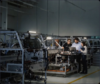 Engineering team reviewing work in a technical workshop